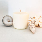 Hygge and Hearth large soy wax candle refill for botanical candles. The candle is on a white background surrounded by large shells.